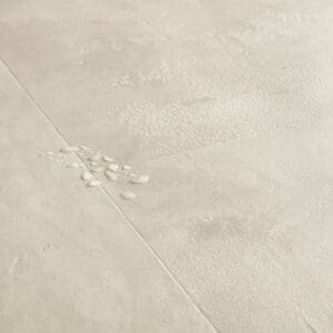 Close-up of water droplets on Quick-Step Muse Stained Concrete flooring showing waterproof properties