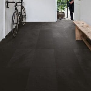 Entryway with wooden bench and bicycle showing Quick-Step Black Slate Laminate flooring