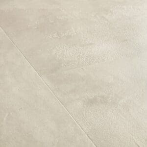 Close-up of water droplets on Quick-Step Muse Stained Concrete flooring from another angle
