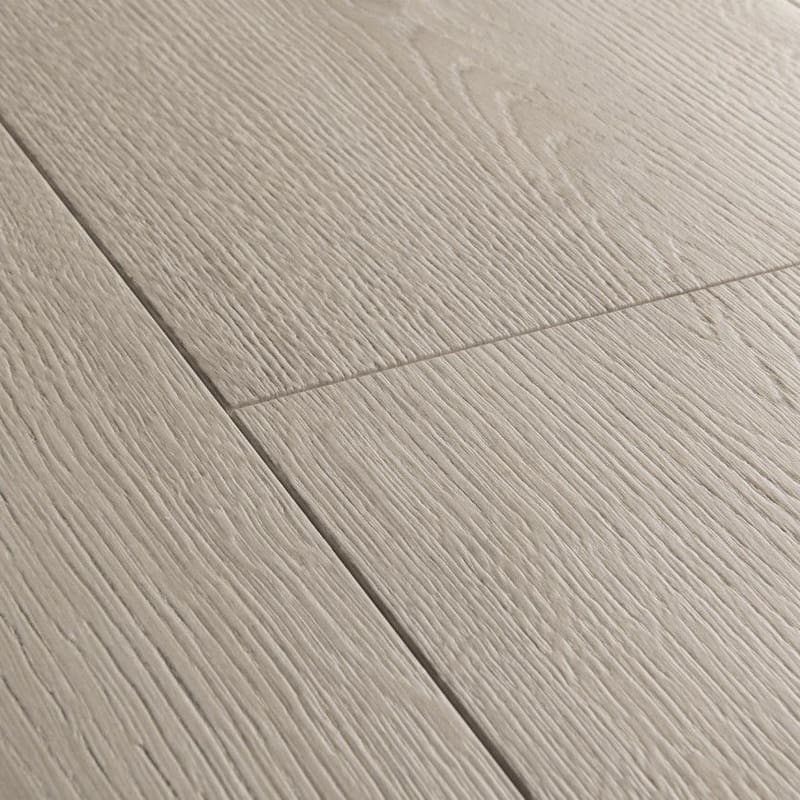 Full room view of Quick-Step Capture Brushed Oak Grey laminate flooring in a bedroom setting