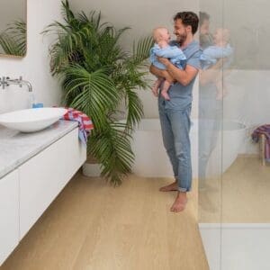 Quick-Step Alpha Blos Gingerbread Oak flooring in a modern bathroom setting