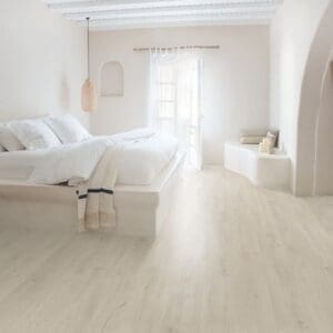 Bright white bedroom with Soft Patina Oak laminate flooring creating a serene atmosphere