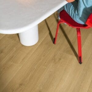 Quick-Step Capture Brushed Oak Warm Natural laminate flooring with orange coffee table and books
