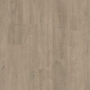 Quick-Step Patina Oak Brown laminate installed in a modern living room with bookshelves
