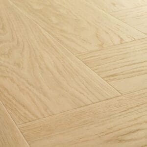 Close-up of Quick-Step Alpha Ciro Pure Oak Blush flooring with water droplets demonstrating waterproof properties