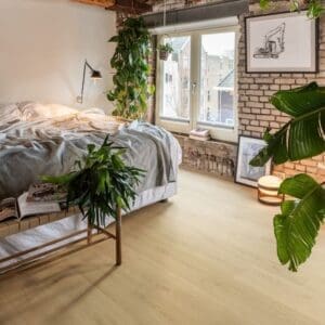Bedroom with exposed brick walls and wooden beams featuring Quick-Step Capture Brushed Oak Natural laminate flooring
