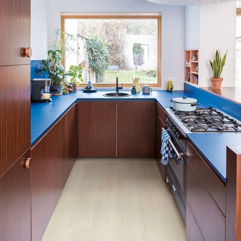 Compact kitchen with blue countertops and light oak vinyl flooring