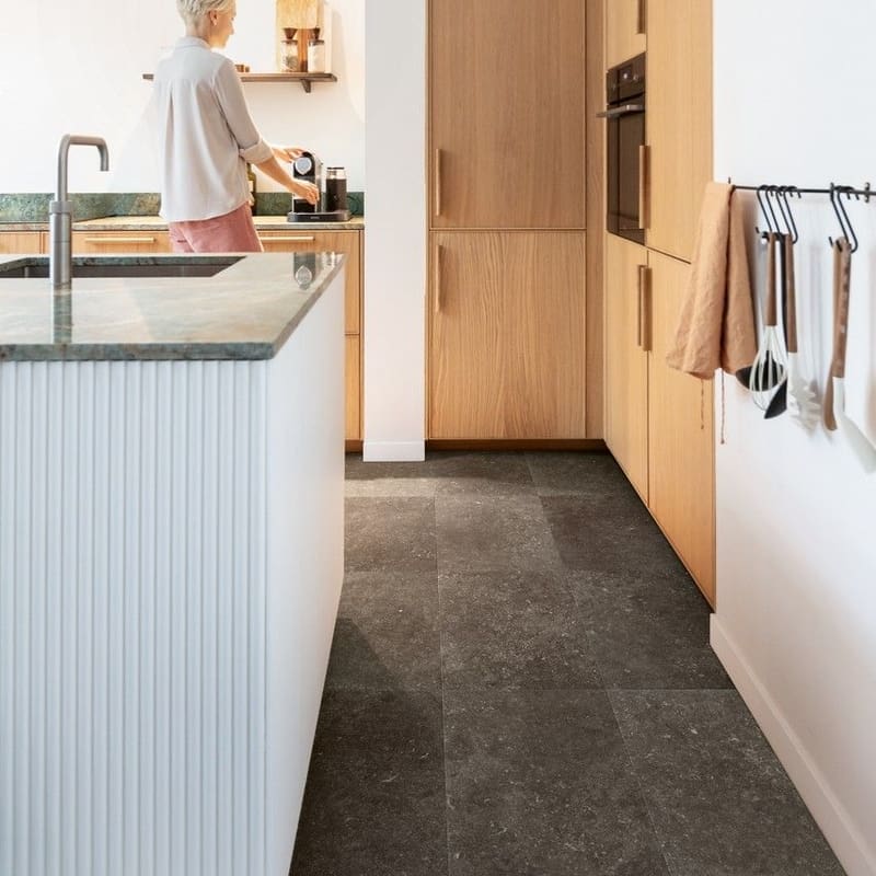 Full view of Quick-Step Fumed Bluestone laminate flooring showing multiple tiles installed in a grid pattern