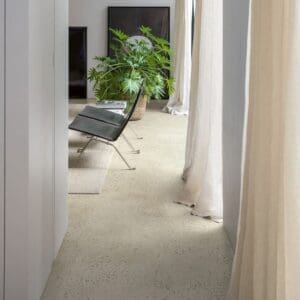 Modern living room with Quick-Step Pebble Concrete flooring, white walls and minimalist furniture