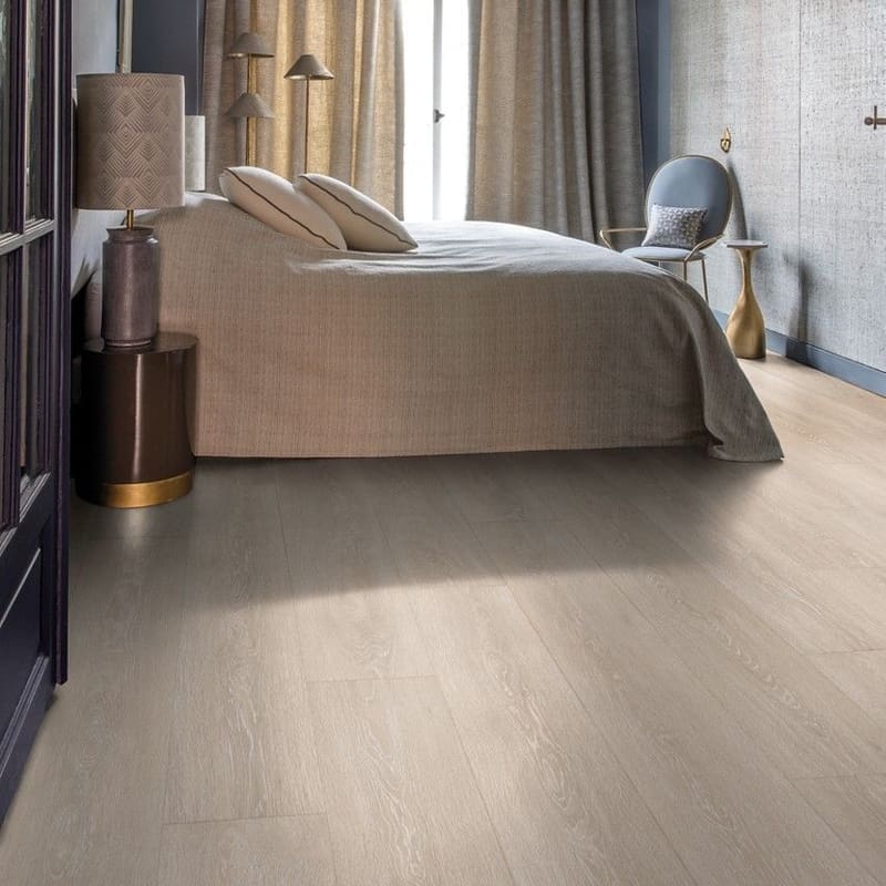 Bedroom with Quick-Step Majestic Valley Oak Light Beige laminate flooring featuring neutral decor and elegant furnishings