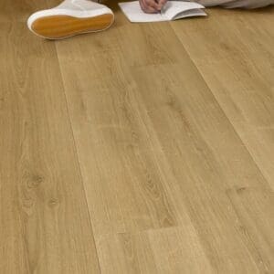 Close-up of Quick-Step Capture Brushed Oak Warm Natural laminate flooring showing water resistance