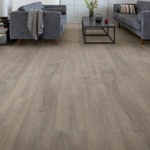 Modern living room with grey sofas featuring Quick-Step Capture Patina Oak Grey laminate flooring