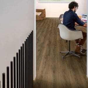 Modern home office with Quick-Step Warm Brown Oak laminate flooring and minimalist furniture