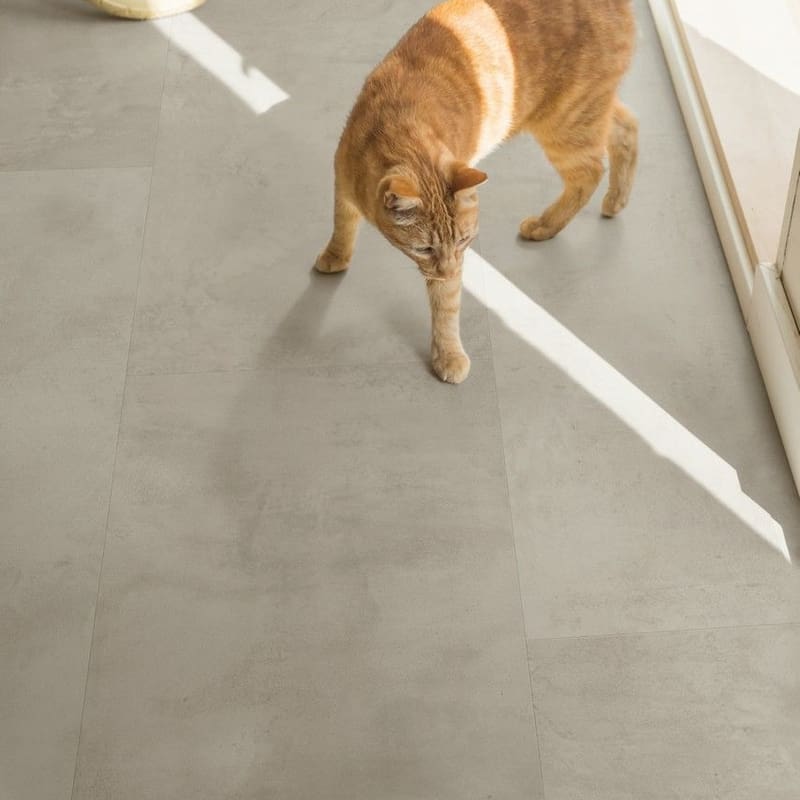 Kitchen with Quick-Step Grey Concrete Laminate flooring and wooden cabinetry
