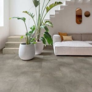Modern living room with Quick-Step Cloudy Concrete flooring, white walls and indoor plants