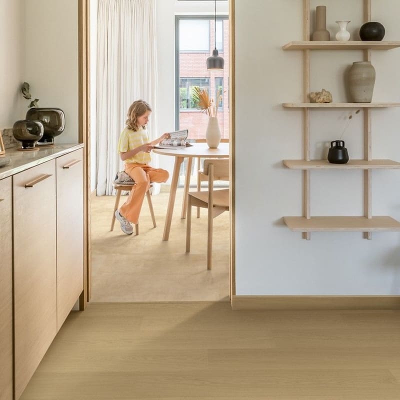Modern dining area with Quick-Step Muse Sandstone laminate flooring installed