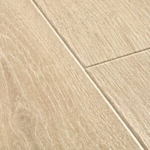 Close-up of Quick-Step Majestic Woodland Oak Beige laminate flooring showing beveled edge detail and wood grain texture