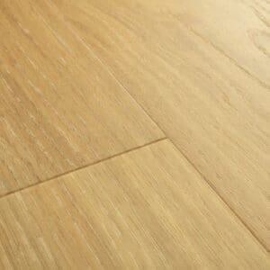 Close-up of Quick-Step Alpha Bloom Pure Oak Honey vinyl flooring showing detailed wood grain texture and plank joints