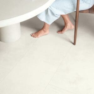 Close-up of Quick-Step Muse Chalk Laminate Flooring MUS5487 with desk and chair showing durability
