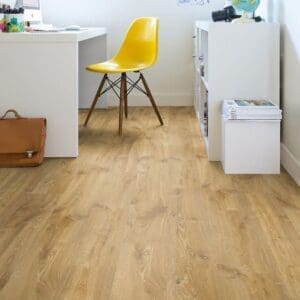 Quick-Step Creo Louisiana Oak Natural Laminate installed in a bright home office with white furniture and yellow accent chair