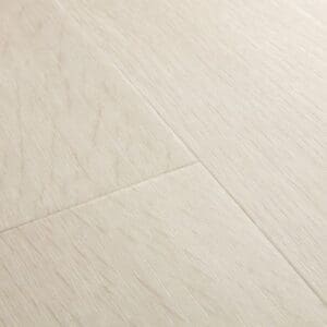 Close-up of Quick-Step Alpha Bloom Sea Breeze Oak Light vinyl flooring showing light beige wood grain pattern and texture