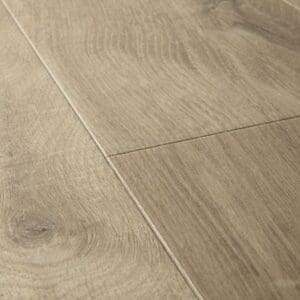 Close-up detail of Quick-Step Impressive Soft Oak Light Brown laminate flooring showing wood grain texture and plank joints