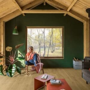 Quick-Step Capture Brushed Oak Warm Natural laminate flooring in a living room with leather furniture