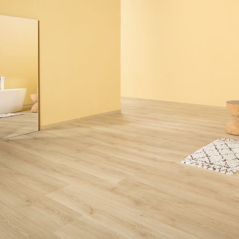 Hand soap and brush on Quick-Step Capture Brushed Oak Natural laminate flooring showing water resistance