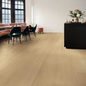 Modern dining area with Quick-Step Capture Beige Varnished Oak flooring, pink seating and black furniture