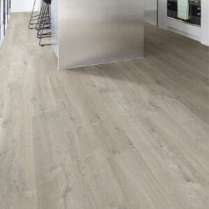Modern kitchen with Quick-Step Impressive Soft Oak Grey laminate flooring installed, showcasing its contemporary appeal
