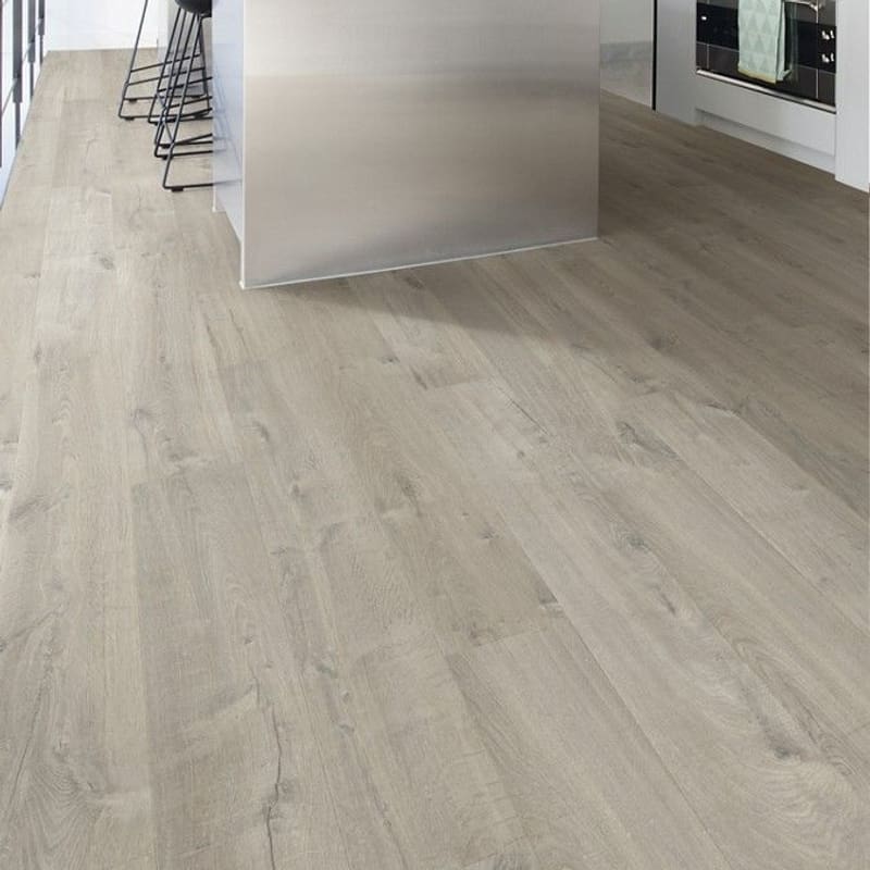 Modern kitchen with Quick-Step Impressive Soft Oak Grey laminate flooring installed, showcasing its contemporary appeal