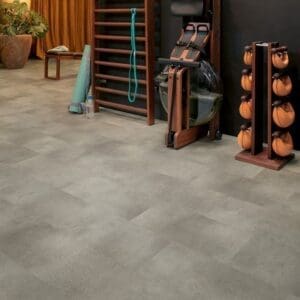 Quick-Step Alpha Oro Concrete Rock flooring in a gym setting with wooden exercise equipment