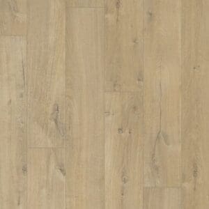 Person relaxing on coral sofa with Quick-Step Soft Oak Medium laminate flooring below