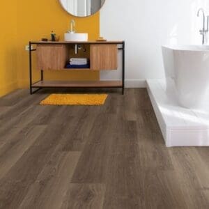 Contemporary living room with person standing by fireplace on Quick-Step Brushed Oak Brown laminate flooring