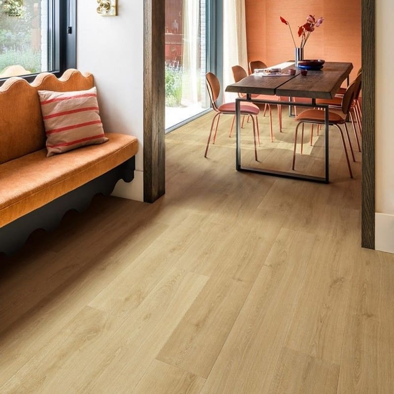 Quick-Step Capture Brushed Oak Warm Natural laminate flooring with person playing guitar and writing
