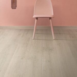 Contemporary dining area with Quick-Step Brushed Oak Beige laminate flooring and dark walls