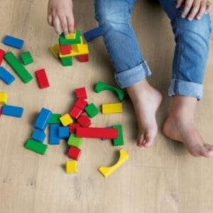 Child playing with colorful building blocks on Quick-Step Soft Oak Medium laminate flooring