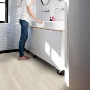Modern bathroom with white subway tiles and light oak vinyl flooring