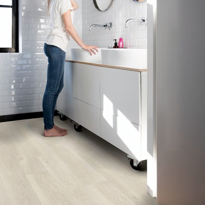 Modern bathroom with white subway tiles and light oak vinyl flooring