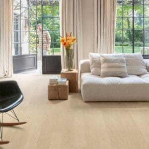 Buttermilk Oak flooring installed in bright living room with large windows