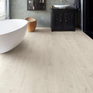 Modern white kitchen with man and dog standing on Soft Patina Oak laminate flooring