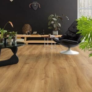 Close-up of Quick-Step Desert Oak Warm Natural laminate flooring showing textured grain and beveled edges