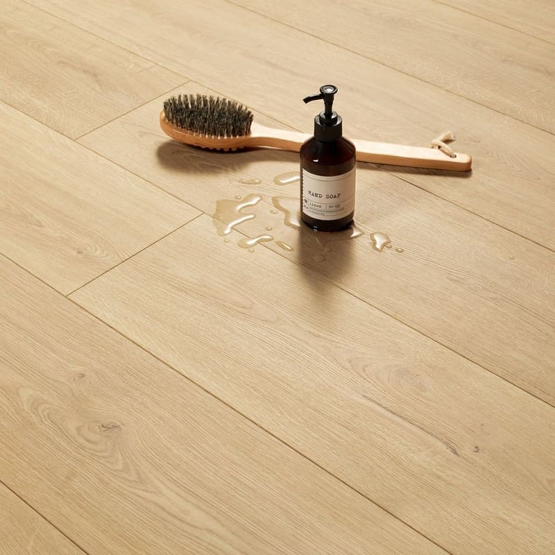 Modern kitchen with gray cabinets and Quick-Step Capture Brushed Oak Natural laminate flooring