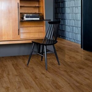 Quick-Step Alpha Bloom Amber Oak flooring installed in a modern study with wooden furniture