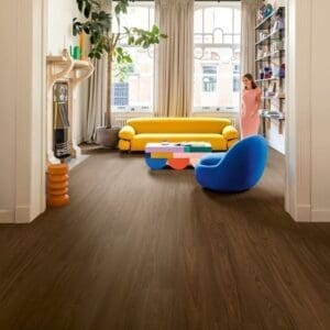 Quick-Step Capture Chic Walnut laminate flooring in a stylish living room with doorway view