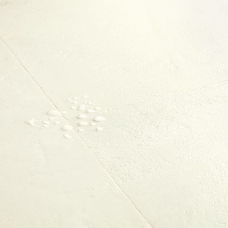 Water droplets on Quick-Step Muse Chalk Laminate Flooring MUS5487 demonstrating waterproof properties