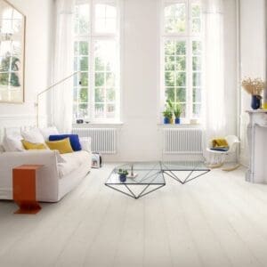 Living room with white laminate flooring, grey sofa, indoor plant and wall art