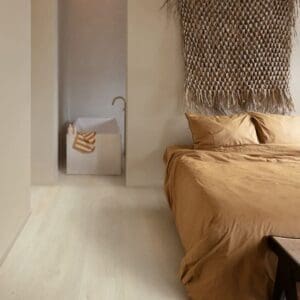 Minimalist bedroom with neutral tones and light oak vinyl flooring