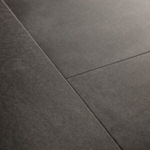 Close-up of Quick-Step Soft Graphite vinyl flooring showing water resistance properties