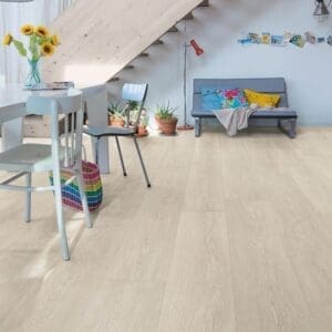 Living space with Quick-Step Majestic Valley Oak Light Beige laminate flooring installed under staircase with modern furniture